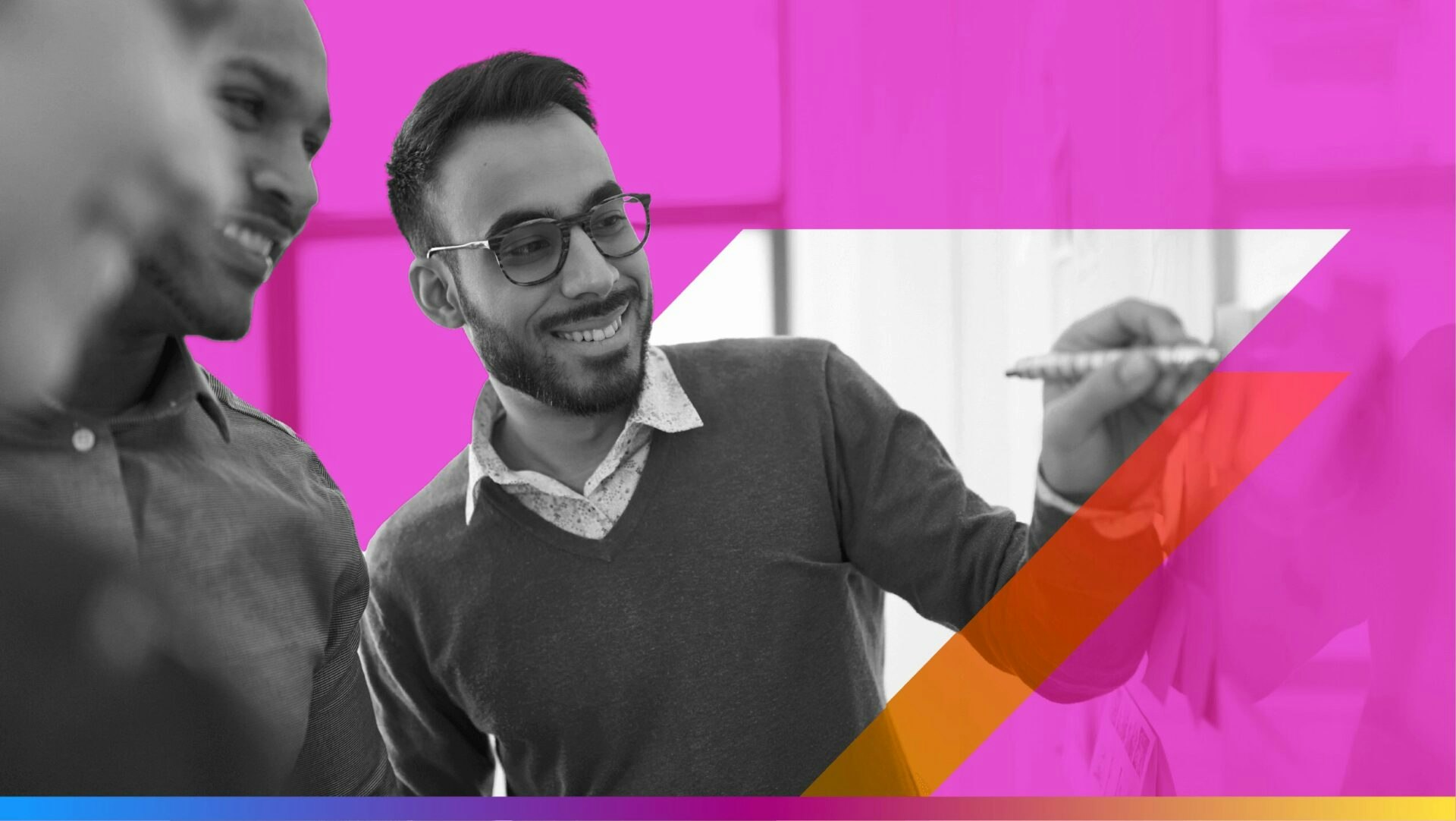 image of two people pointing at a whiteboard in an office setting - featured image for deterministic-first measurement article