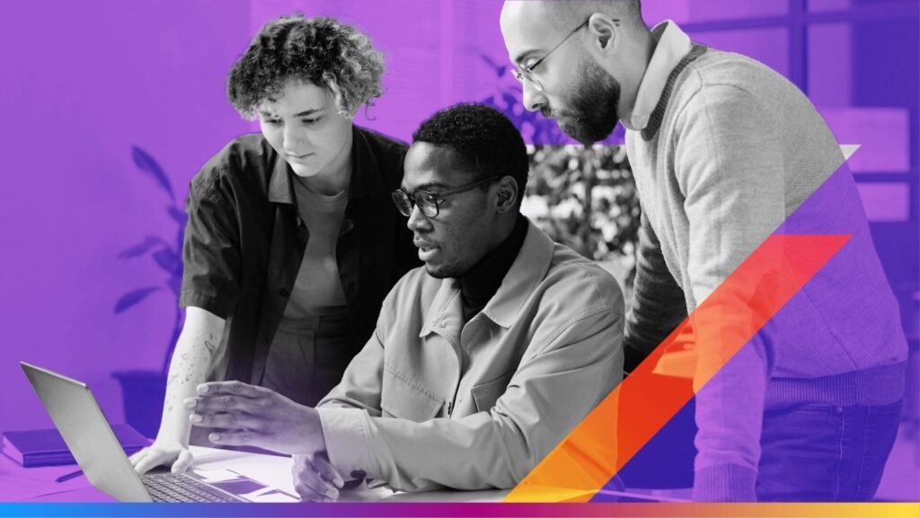 people at work huddled around a computer - featured image for the AI and modern marketing agency article